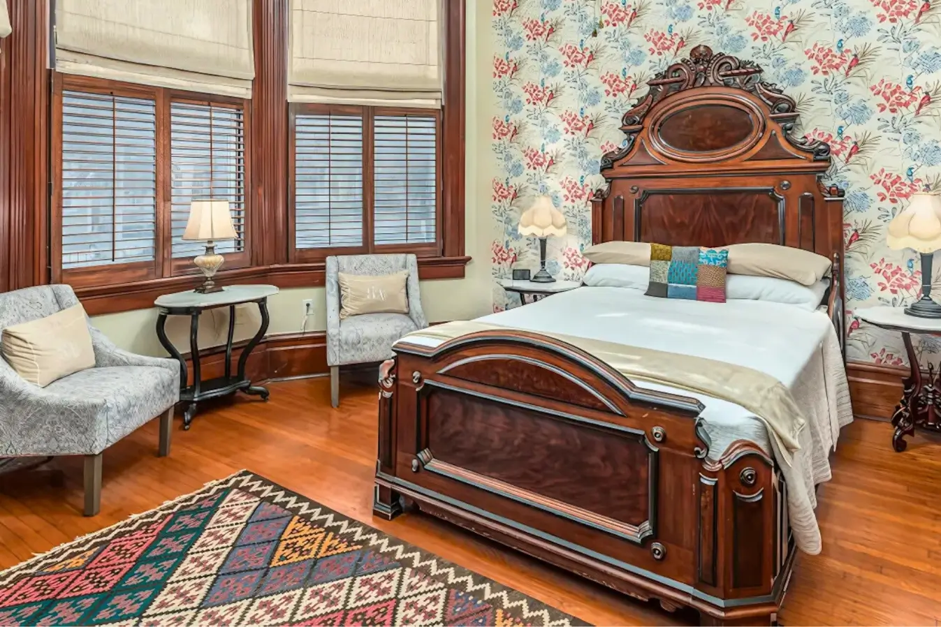 Vintage-Inspired Boutique Hotel Room with Antique Wooden Bed and Floral Wallpaper"